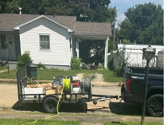 The Precision Power Washing truck and equipment trailer parked on a job in town